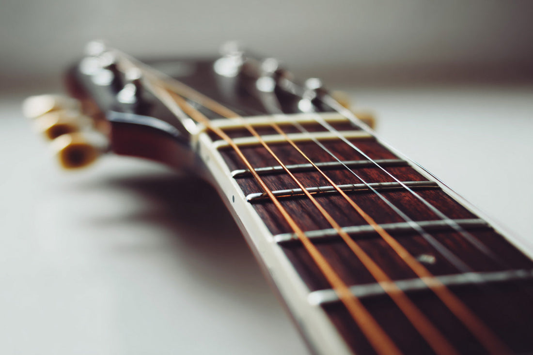 Electric guitar neck with strings in focus