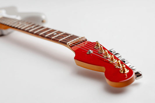 Red guitar headstock on a white background