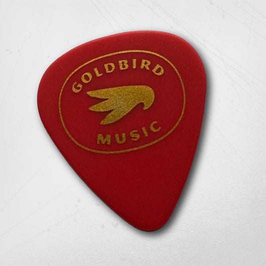 Red guitar pick with gold 'Goldbird Music' logo on a white background