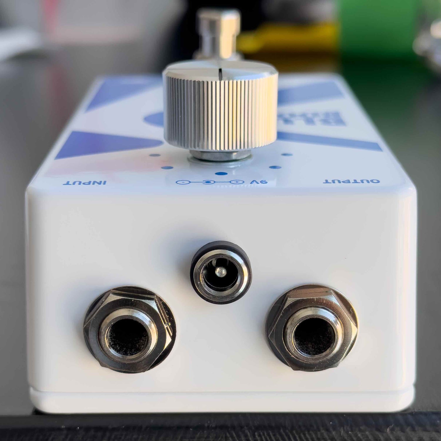 Blue Boost guitar pedal top with three jacks and knob on top