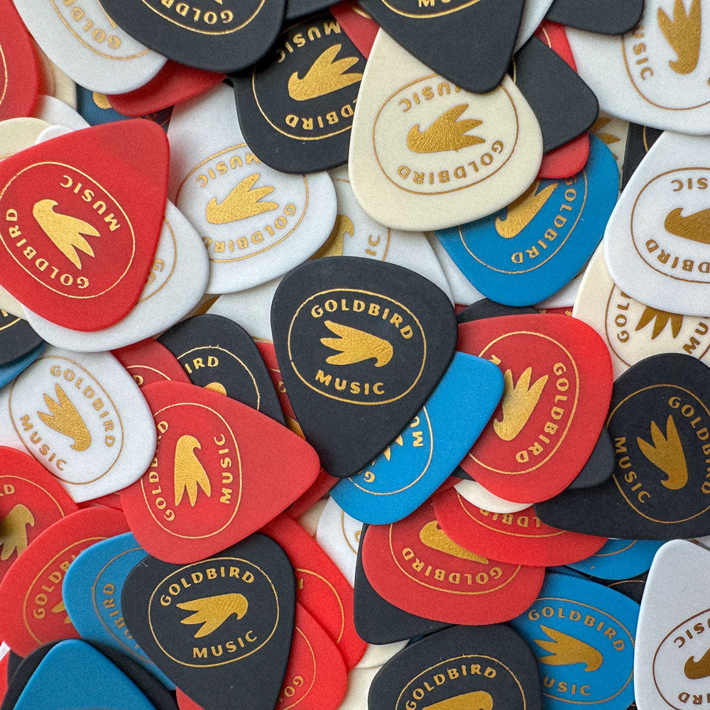 Collection of guitar picks with Goldbird Music branding.