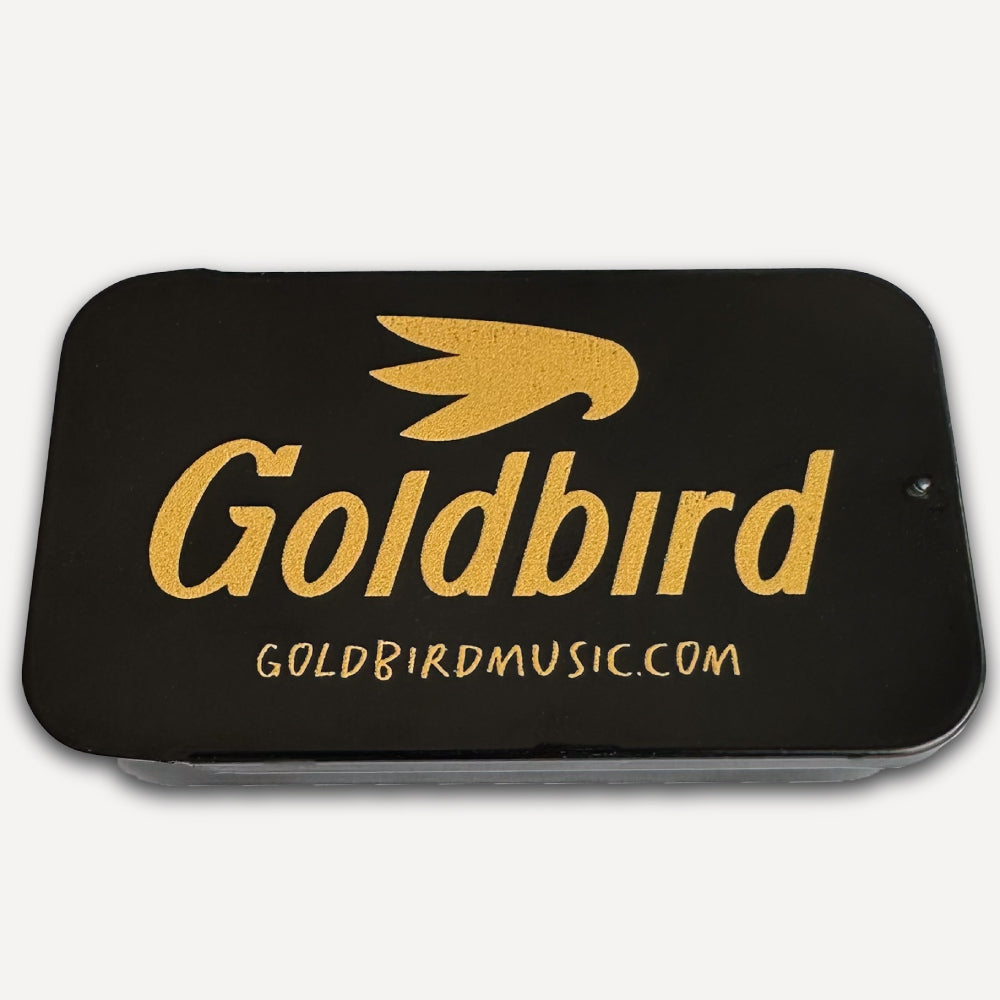 Black guitar pick tin with gold Goldbird logo and website text on a white background